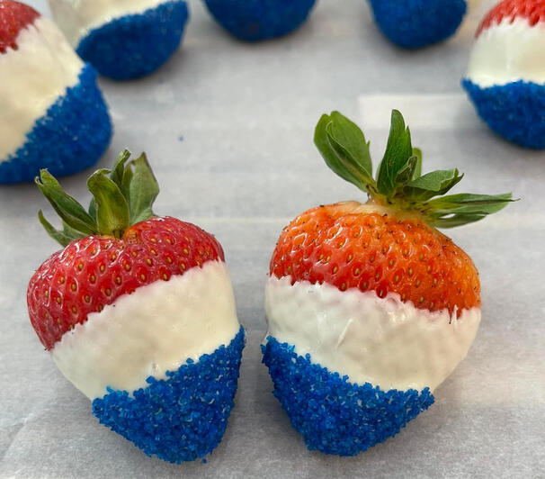 White chocolate covered strawberries dipped in blue sugar.